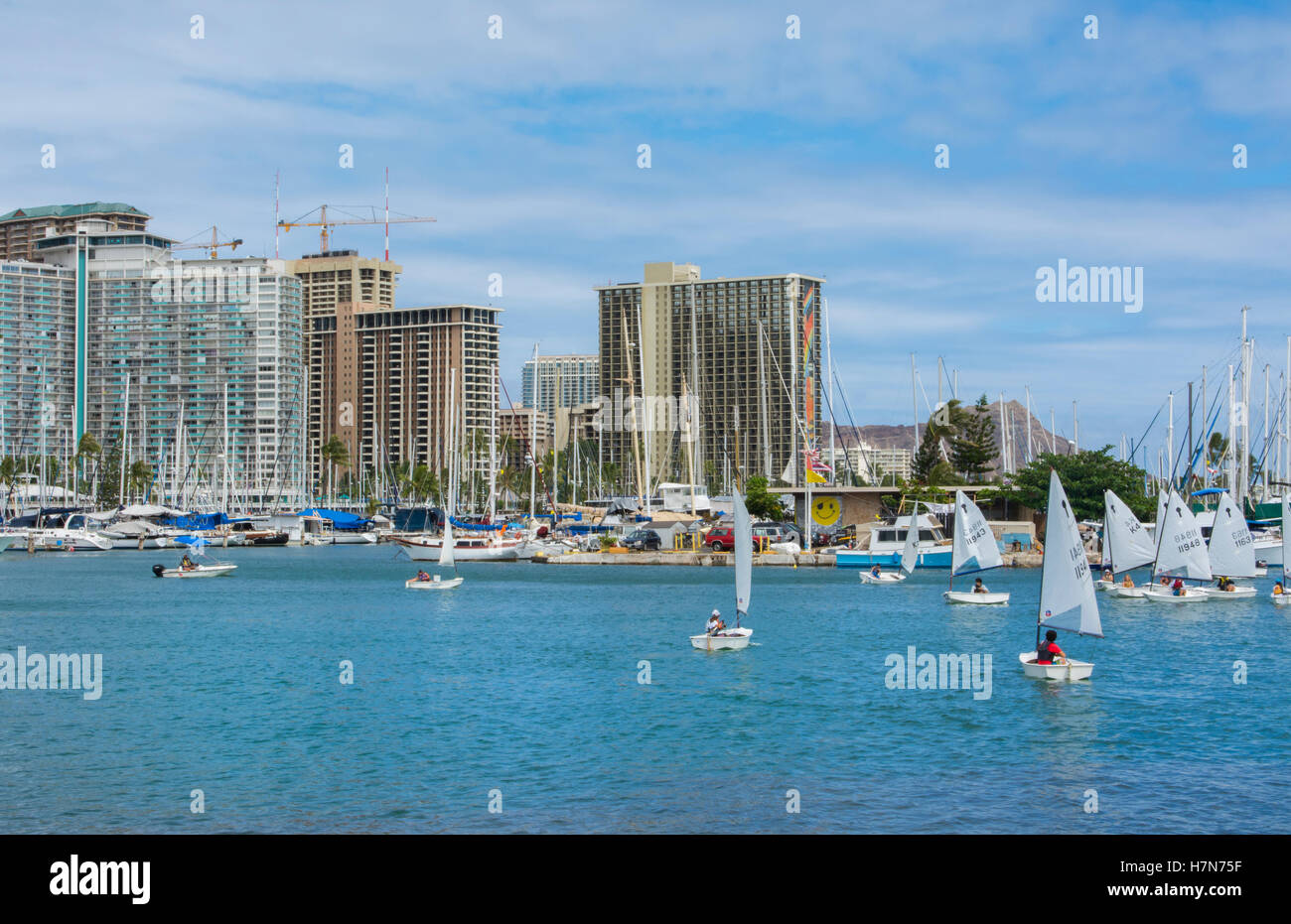 Honolulu Hawaii Oahu skyline from boat marina with sailboats school on