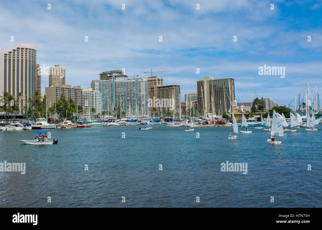 Honolulu Hawaii Oahu skyline from boat marina with sailboats school on