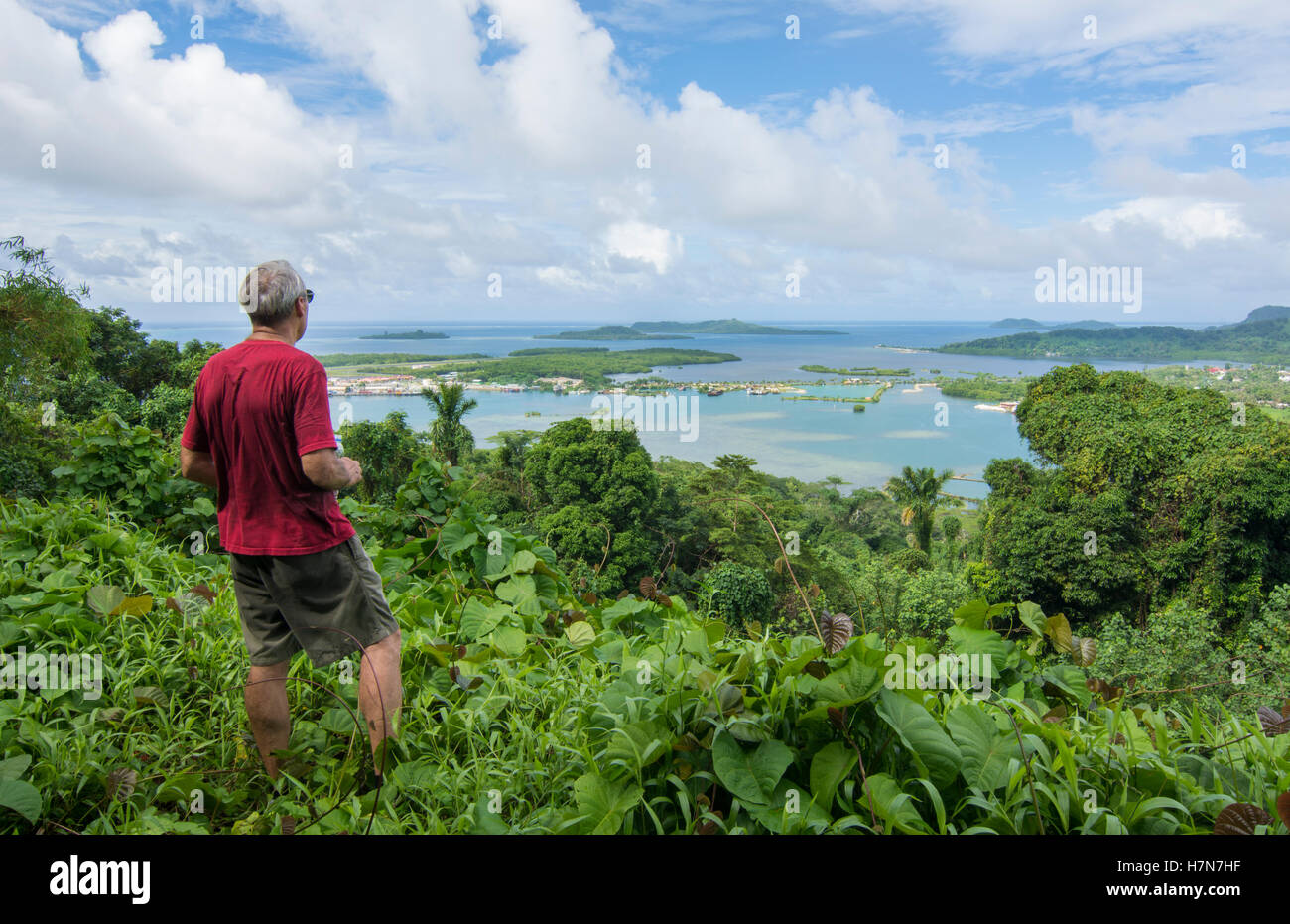 Pohnpei Micronesia man with binoculars looking at city of Kolonia from famous Sokehs Ridge Stock Photo