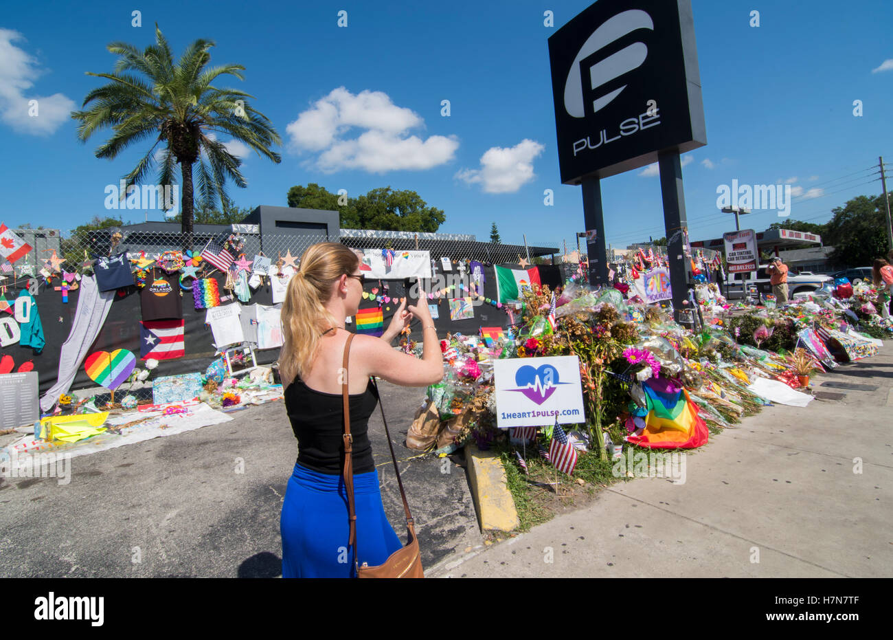 Orlando Florida Pulse night club tragedy shooting memorial at gay bar by terrorist on June 12, 2016, woman taking photos Stock Photo