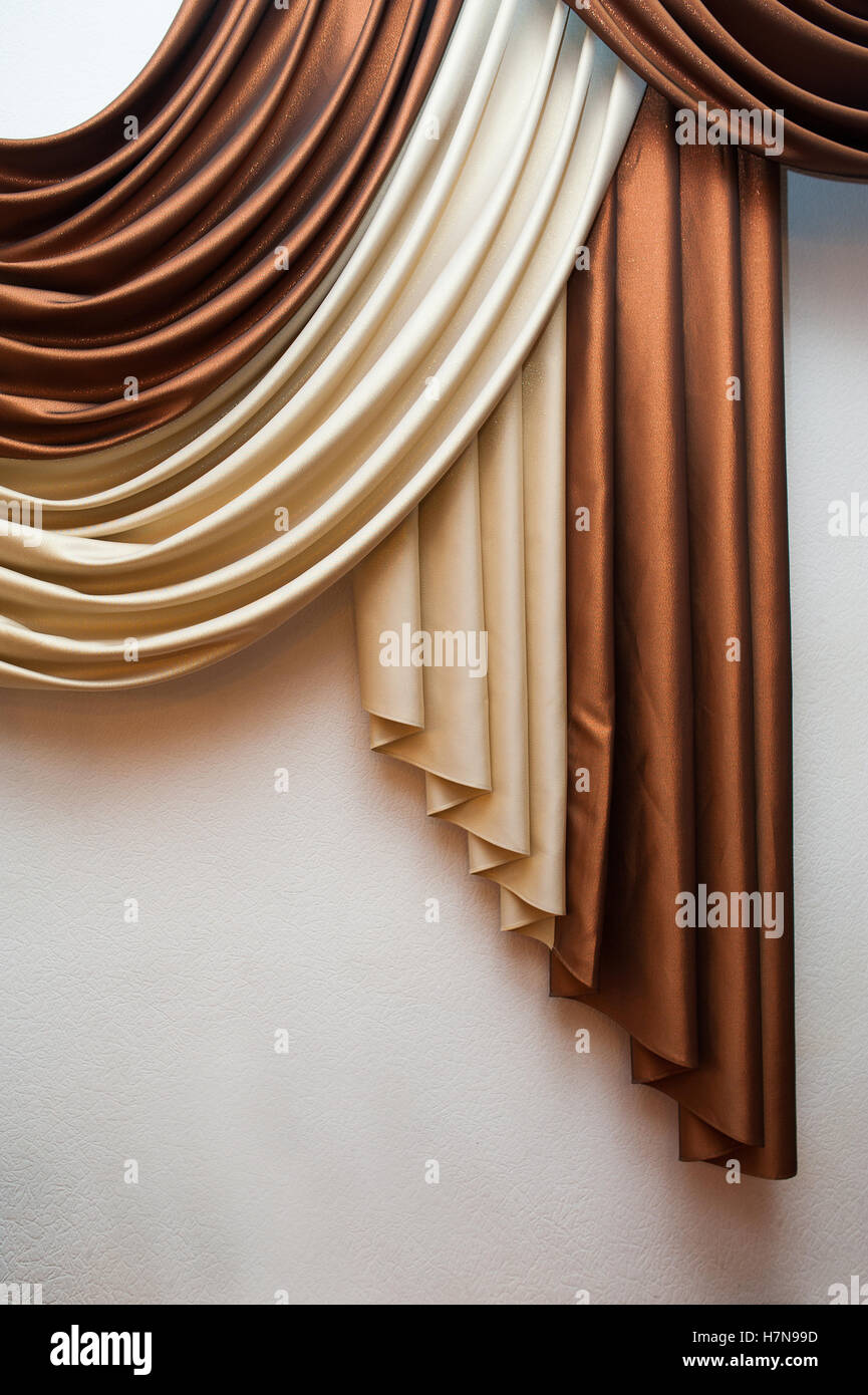 Part of beautifully draped curtain and wall with patterns Stock Photo