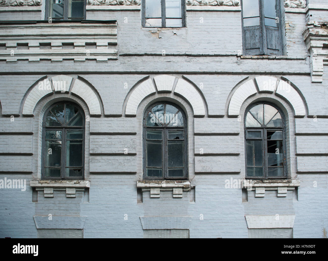 Facade of old abandoned building with three large arched windows Stock ...