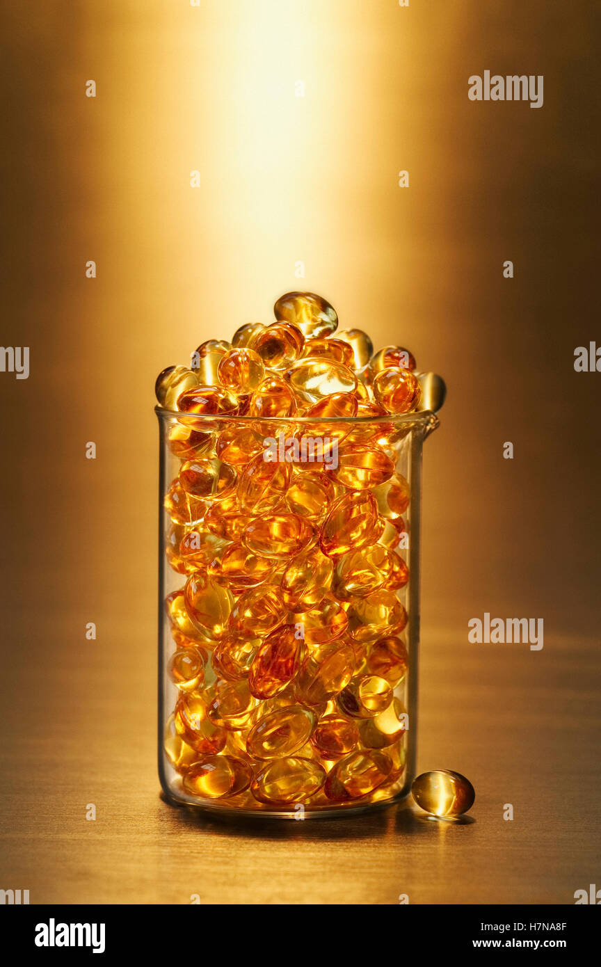 Glass medical beaker full of pills Stock Photo Alamy