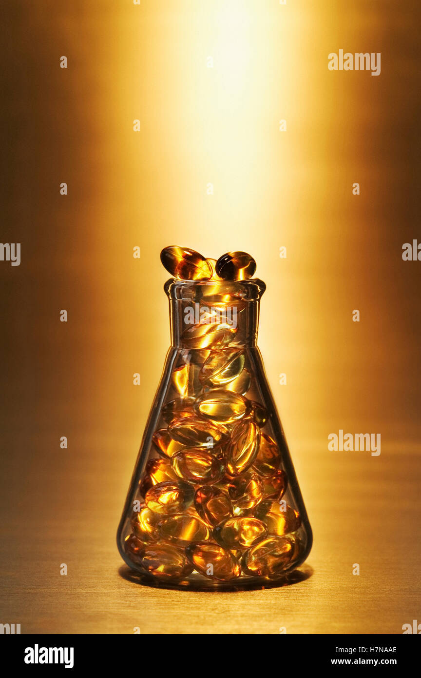 Glass medical beaker full of pills Stock Photo Alamy