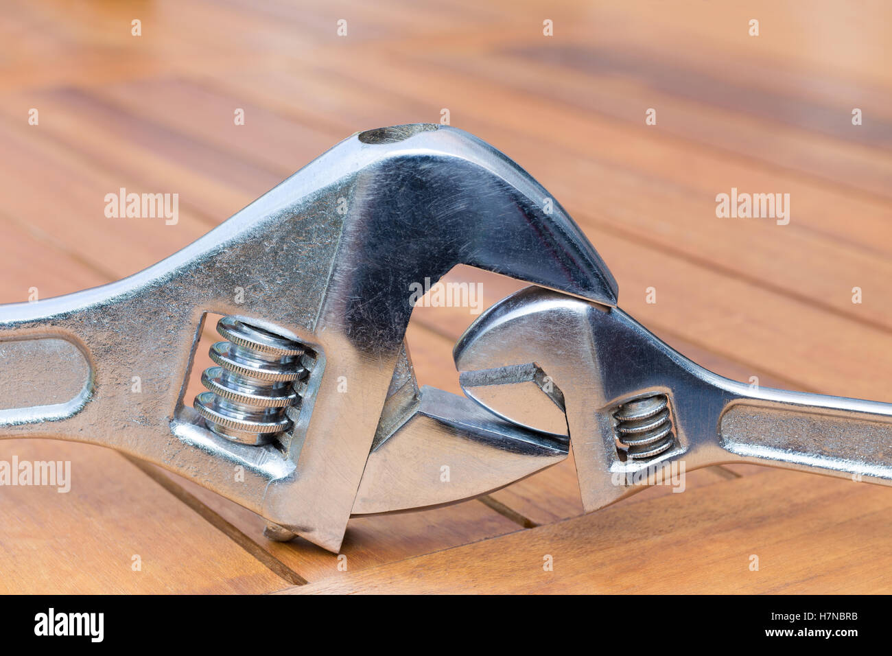 Big and little adjustable wrenches together on wooden table Stock Photo