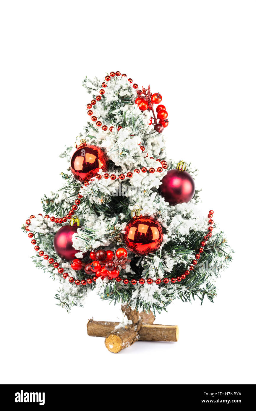 Little decorated christmas tree with baubles and snow isolated on white background Stock Photo