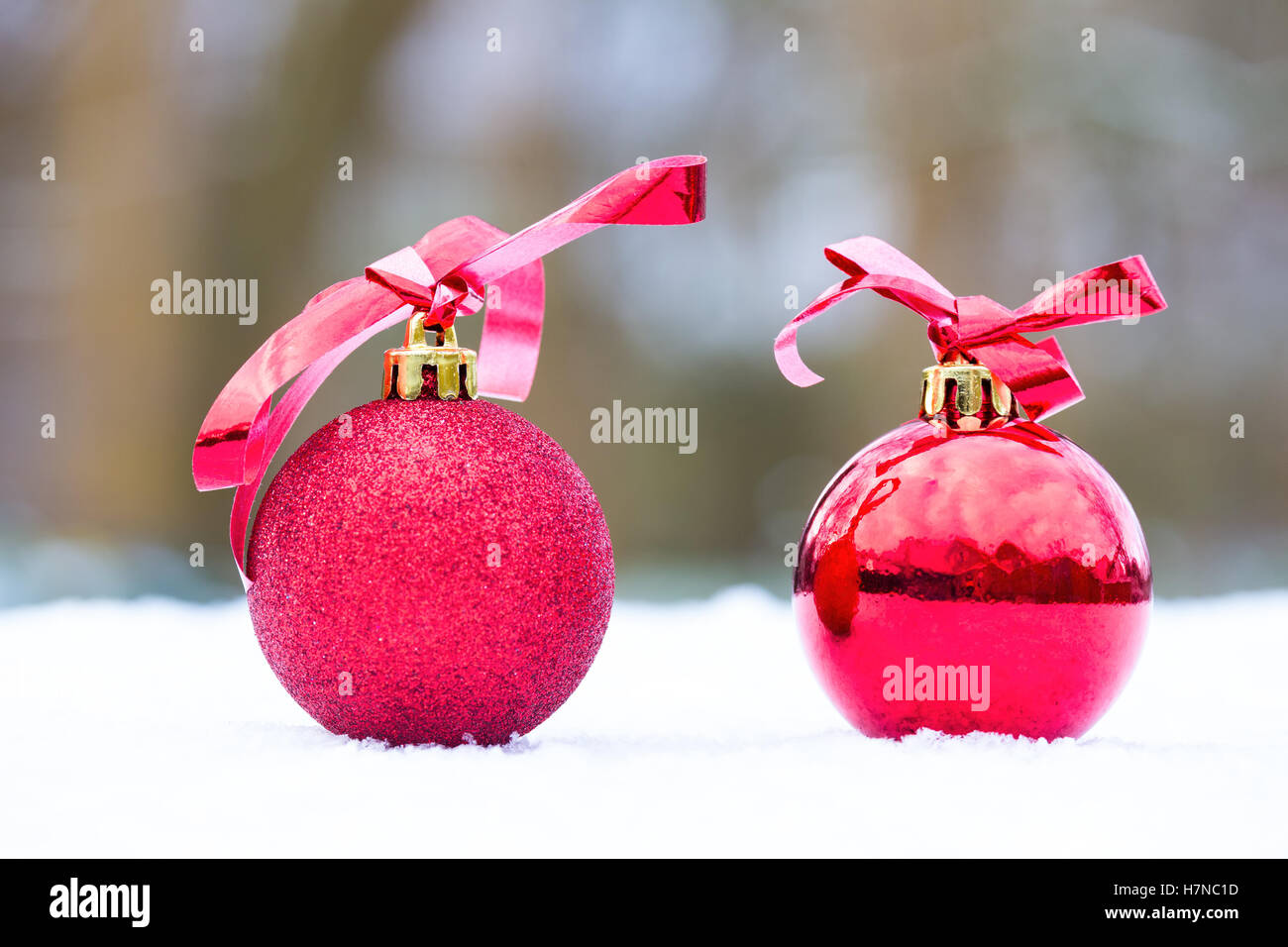 Two red christmas baubles outdoors in white snow Stock Photo