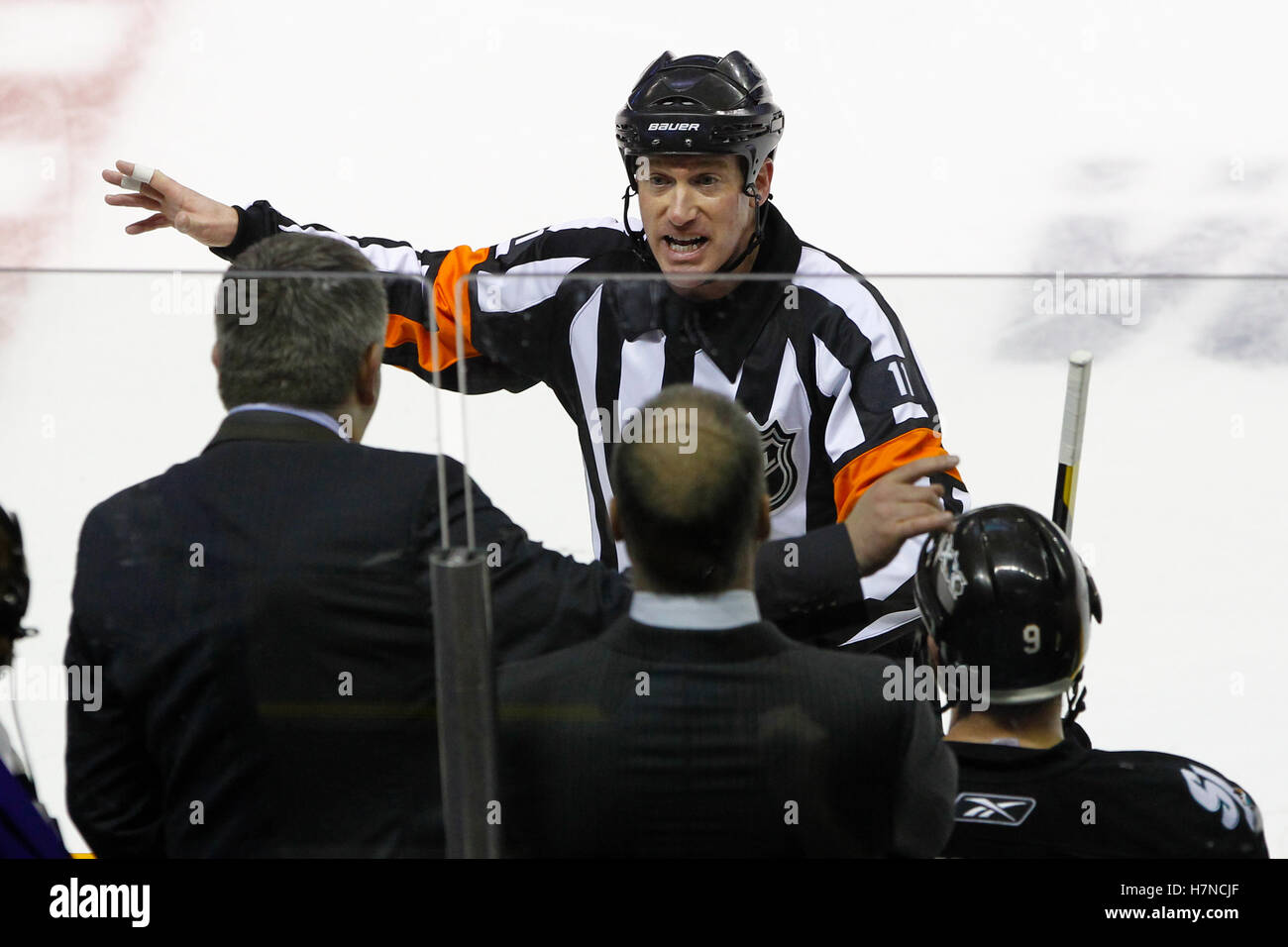 May 22, 2011; San Jose, CA, USA;  NHL referee Kelly Sutherland (11) explains a call to San Jose Sharks head coach Todd McLellan (left) during the second period of game four of the western conference finals of the 2011 Stanley Cup playoffs against the Vancouver Canucks at HP Pavilion.  Vancouver defeated San Jose 4-2. Stock Photo