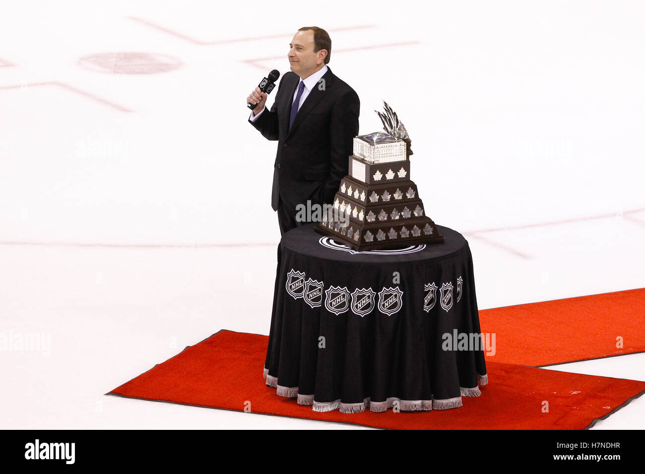 June 15, 2011; Vancouver, BC, CANADA; NHL commissioner Gary Bettman presents the Conn Smythe trophy to Boston Bruins goalie Tim Thomas (not pictured) after game seven of the 2011 Stanley Cup Finals against the Vancouver Canucks at Rogers Arena. Boston defeated Vancouver 4-0. Stock Photo