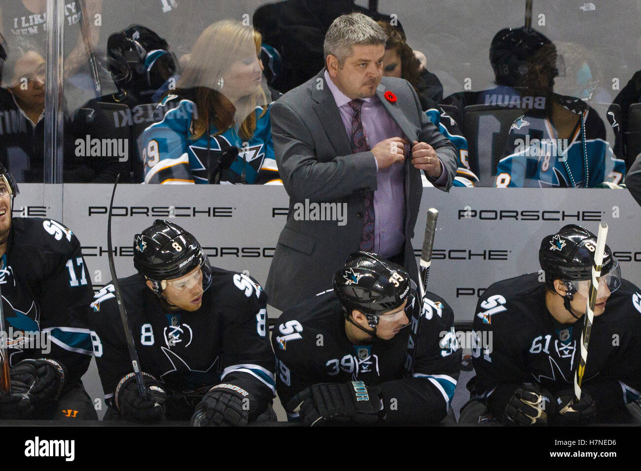 Nov 10, 2011; San Jose, CA, USA; San Jose Sharks head coach Todd McLellan (center, back) stands behind the bench against the Minnesota Wild during the second period at HP Pavilion.  San Jose defeated Minnesota 3-1. Stock Photo