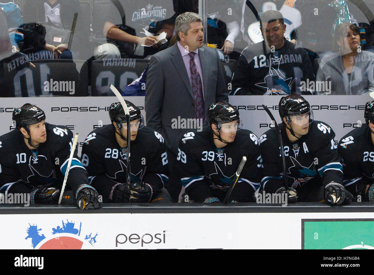 Dec 23, 2011; San Jose, CA, USA; San Jose Sharks head coach Todd McLellan stands behind the bench against the Los Angeles Kings during the third period at HP Pavilion. San Jose defeated Los Angeles 2-1 in shootouts. Stock Photo