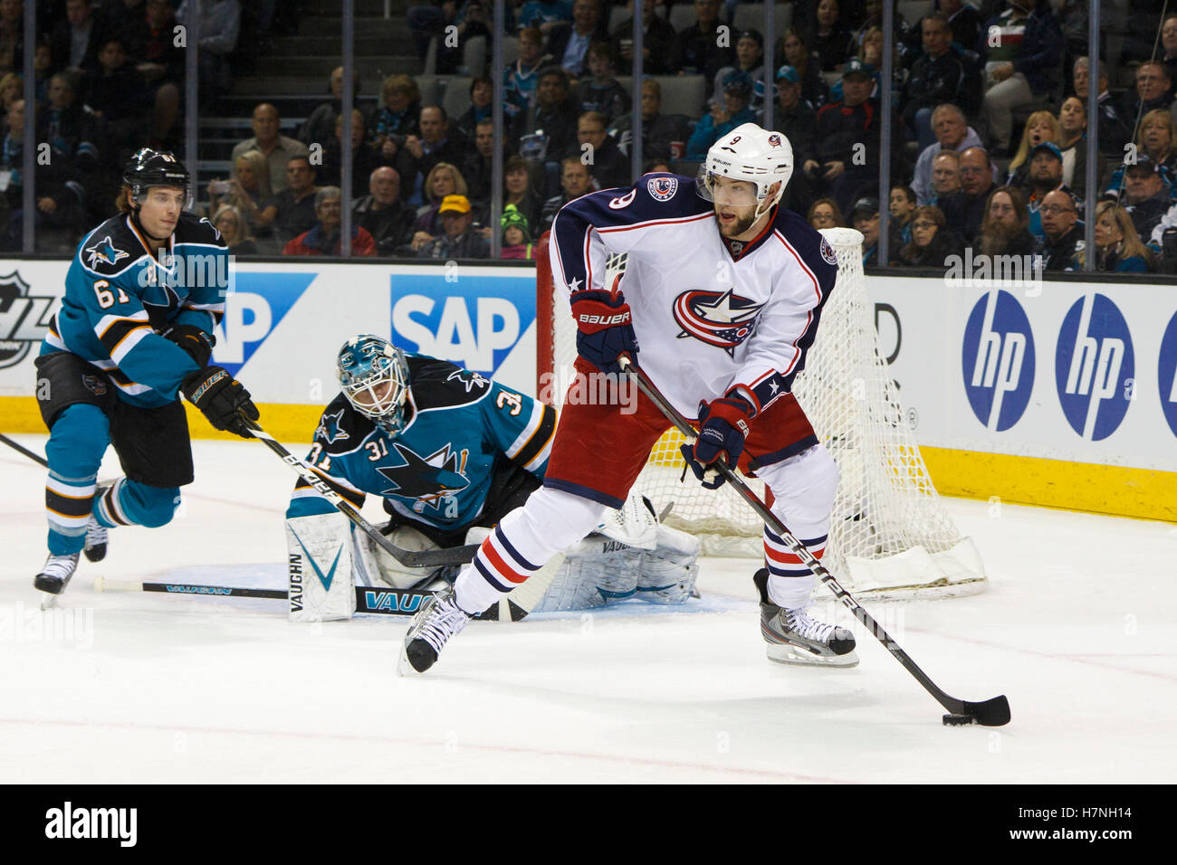 Jan 31, 2012; San Jose, CA, USA; Columbus Blue Jackets left wing Colton Gillies (9) skates with the puck in front of San Jose Sharks goalie Antti Niemi (31) and defenseman Justin Braun (61) during the first period at HP Pavilion. San Jose defeated Columbus 6-0. Stock Photo