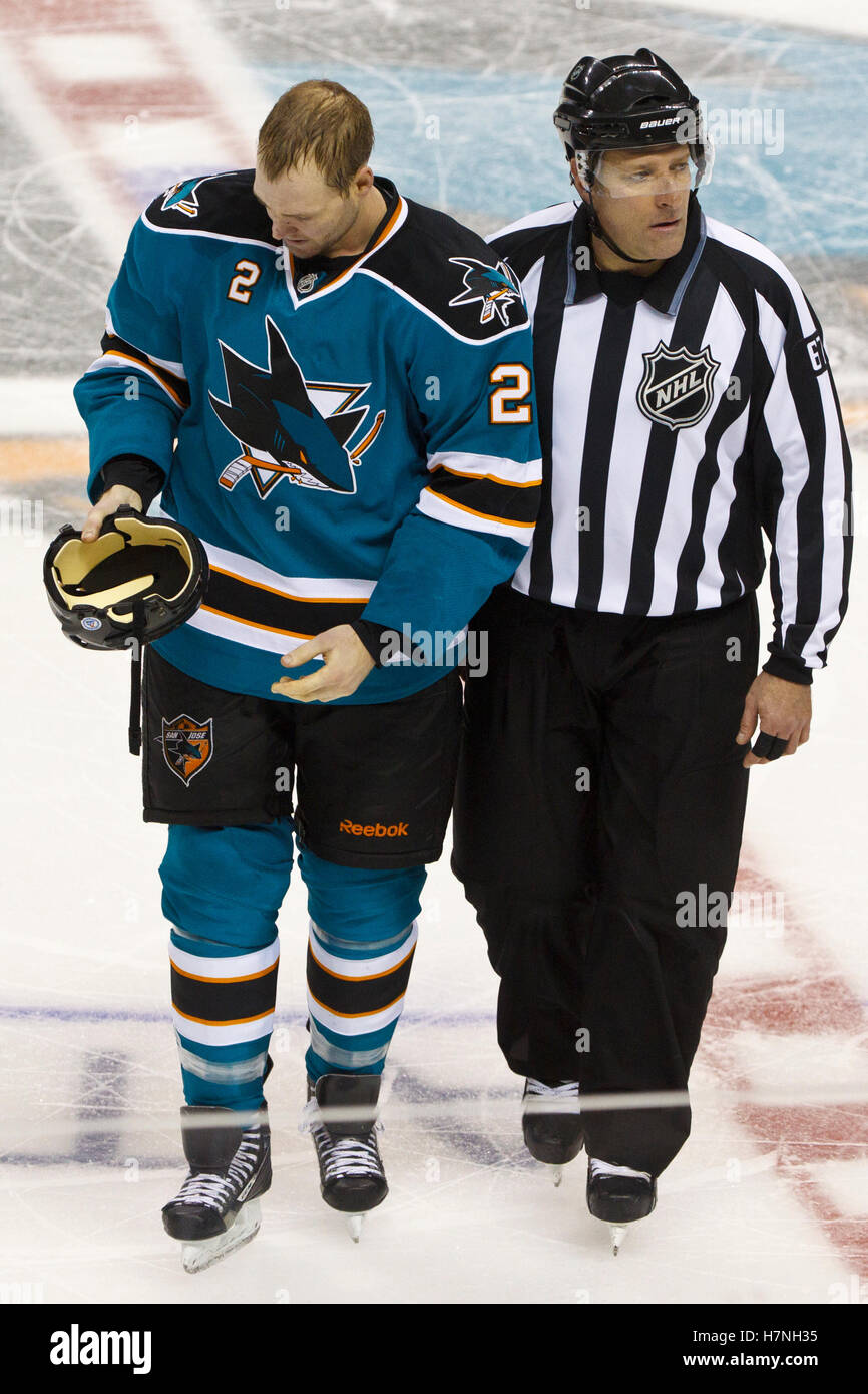Jan 31, 2012; San Jose, CA, USA; San Jose Sharks defenseman Jim Vandermeer (2) is escorted to the penalty box by NHL linesman Pierre Champoux (67) after fighting Columbus Blue Jackets right wing Jared Boll (not pictured) during the third period at HP Pavilion. San Jose defeated Columbus 6-0. Stock Photo