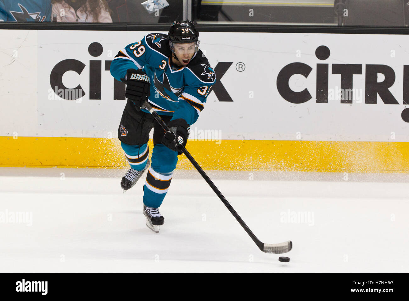 Feb 8, 2012; San Jose, CA, USA; San Jose Sharks center Logan Couture (39) passes the puck against the Calgary Flames during the first period at HP Pavilion. Stock Photo