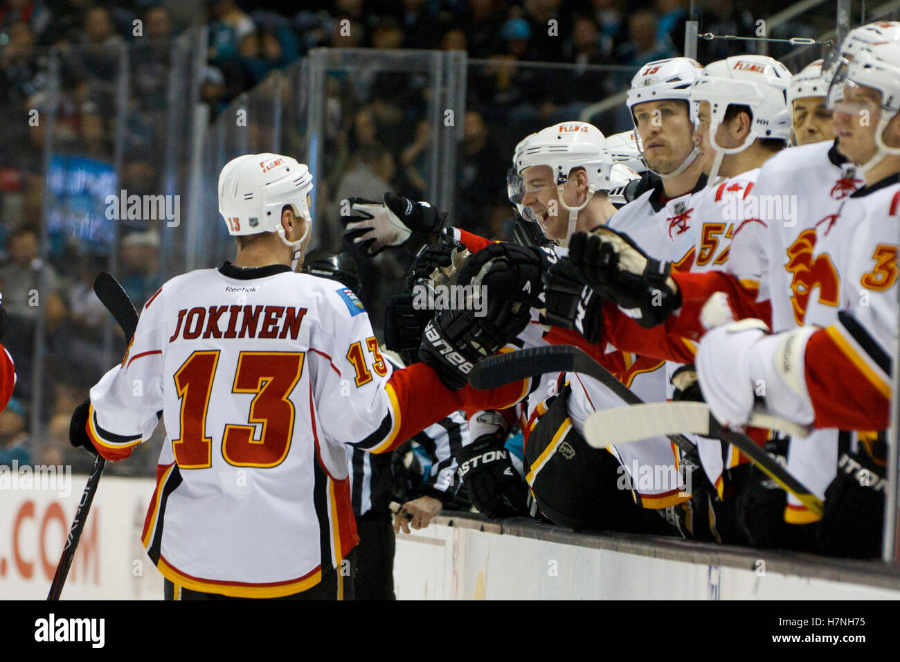 Feb 8, 2012; San Jose, CA, USA; Calgary Flames center Olli Jokinen (13) is congratulated by teammates after scoring a goal against the San Jose Sharks during the second period at HP Pavilion. Stock Photo