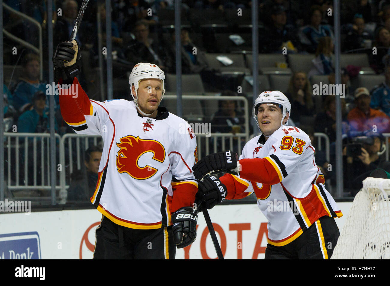 Feb 8, 2012; San Jose, CA, USA; Calgary Flames center Olli Jokinen (left) celebrates after scoring a goal against the San Jose Sharks during the second period at HP Pavilion. Stock Photo