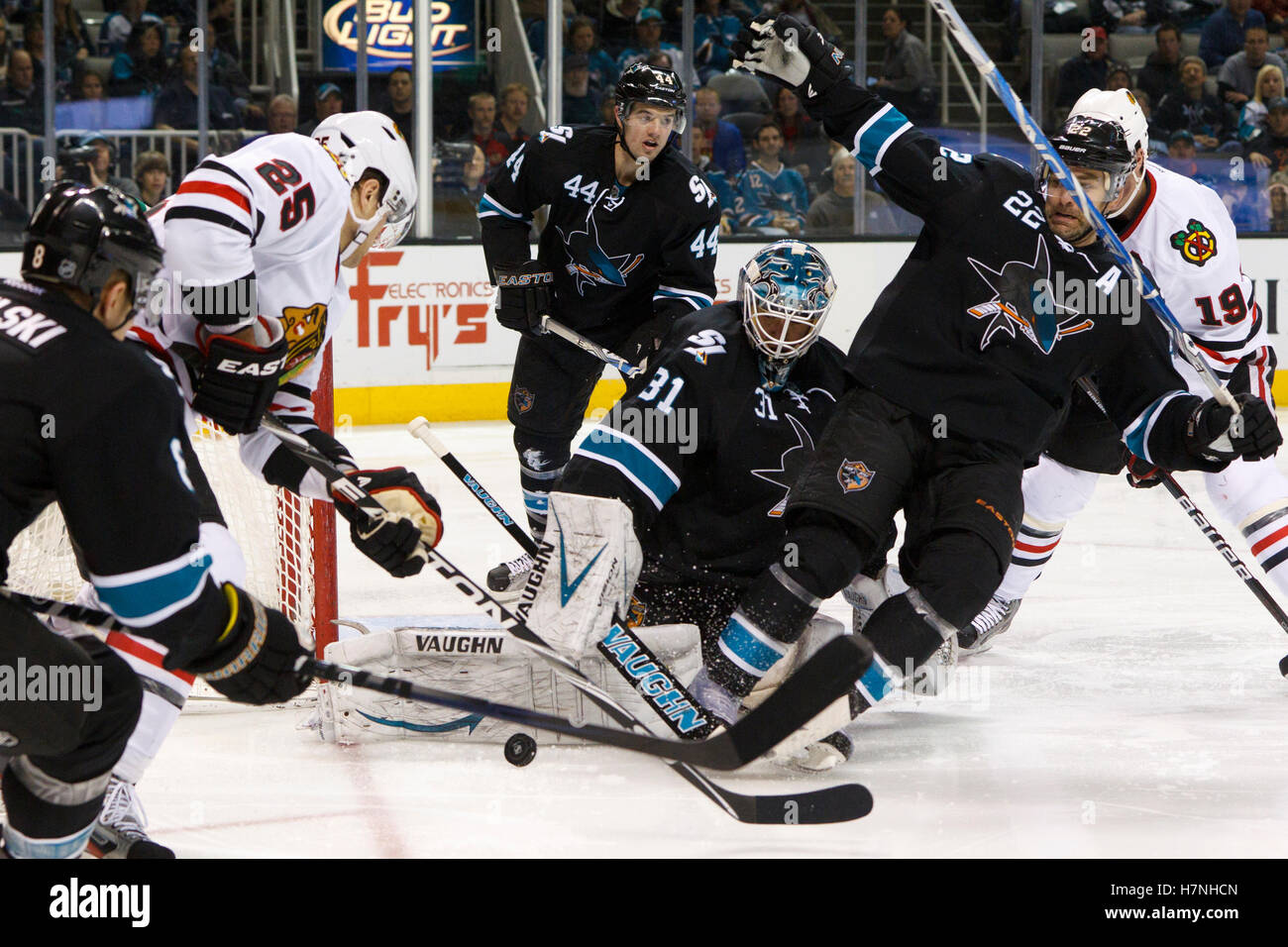 Feb 10, 2012; San Jose, CA, USA; San Jose Sharks goalie Antti Niemi (31) saves a shot with defenseman Dan Boyle (22) in front of Chicago Blackhawks left wing Viktor Stalberg (25) during the second period at HP Pavilion. Stock Photo