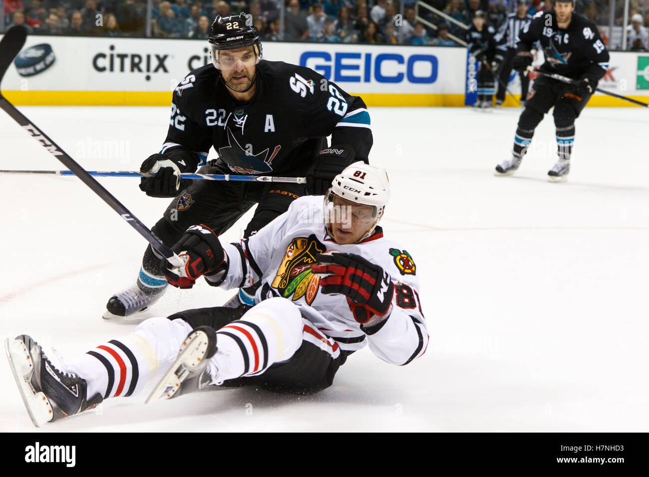 Feb 10, 2012; San Jose, CA, USA; Chicago Blackhawks right wing Marian Hossa (81) is knocked to the ice by San Jose Sharks defenseman Dan Boyle (22) during the second period at HP Pavilion. Stock Photo