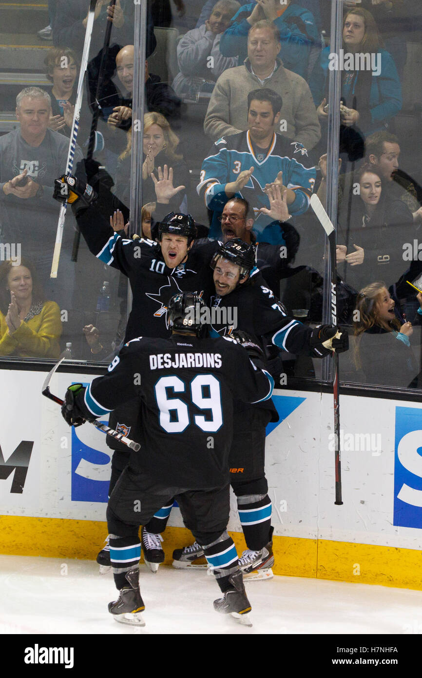 Feb 10, 2012; San Jose, CA, USA; San Jose Sharks center Benn Ferriero (right) is congratulated by left wing Brad Winchester (10) and center Andrew Desjardins (69) after scoring a goal against the Chicago Blackhawks during the third period at HP Pavilion. San Jose defeated Chicago 5-3. Stock Photo
