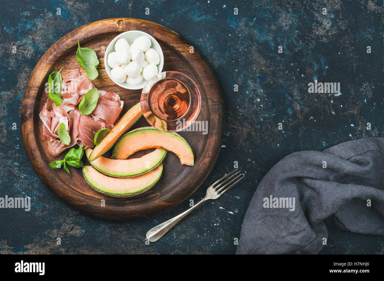 Prosciutto, cantaloupe melon, mozzarella and glass of rose wine Stock