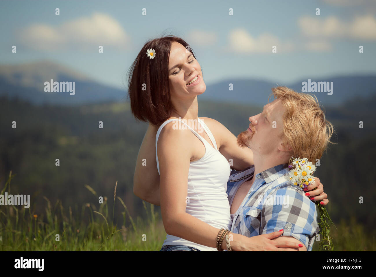 Happy beautiful couple in love on the green grass field Stock Photo - Alamy