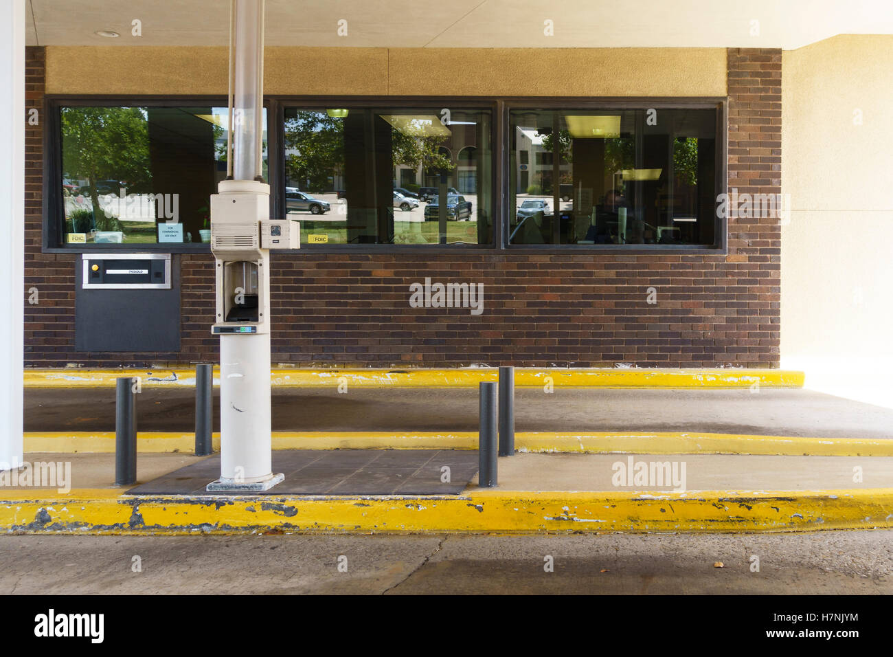 A pneumatic vacuum tube in a drive through area of a bank in Oklahoma City, Oklahoma, USA. Stock Photo