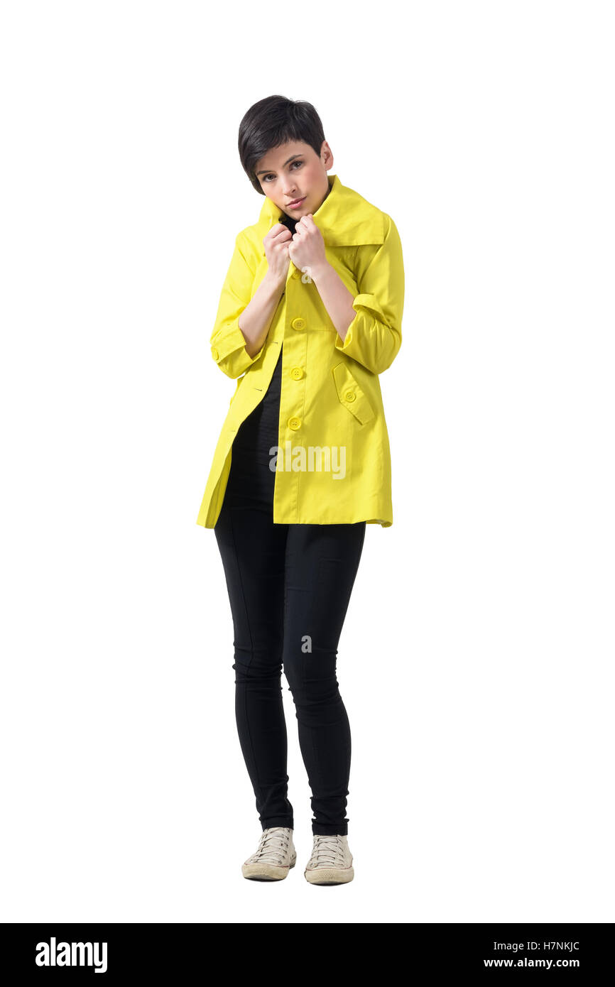Young Short Hair Brunette Freezing Covering Neck With Yellow Rain