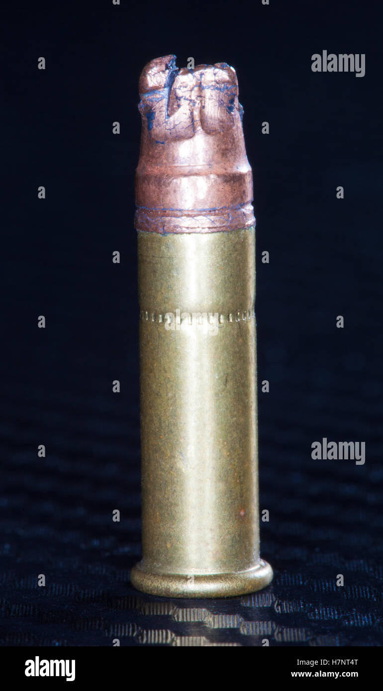 Rimfire cartridge for a 22 that has a bullet severely bent Stock Photo ...