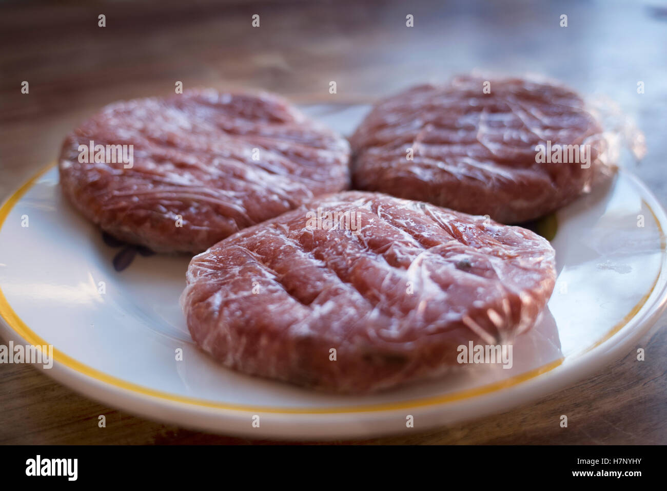 frozen meat hamburger wrapped in plastic film Stock Photo Alamy