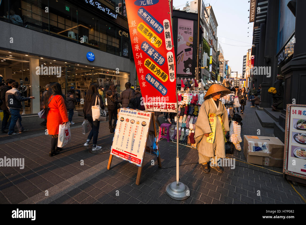 Modern sandwich man wearing traditional Korean costume in the street of Myeongdong, Seoul Stock Photo