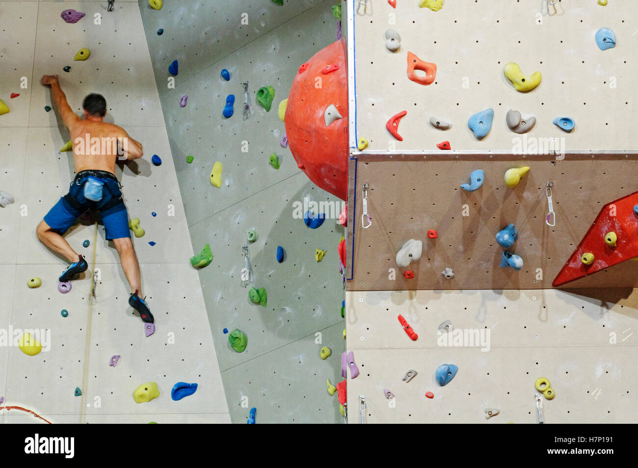 Man Climbing with Ropes on Climbing Wall Stock Photo - Alamy