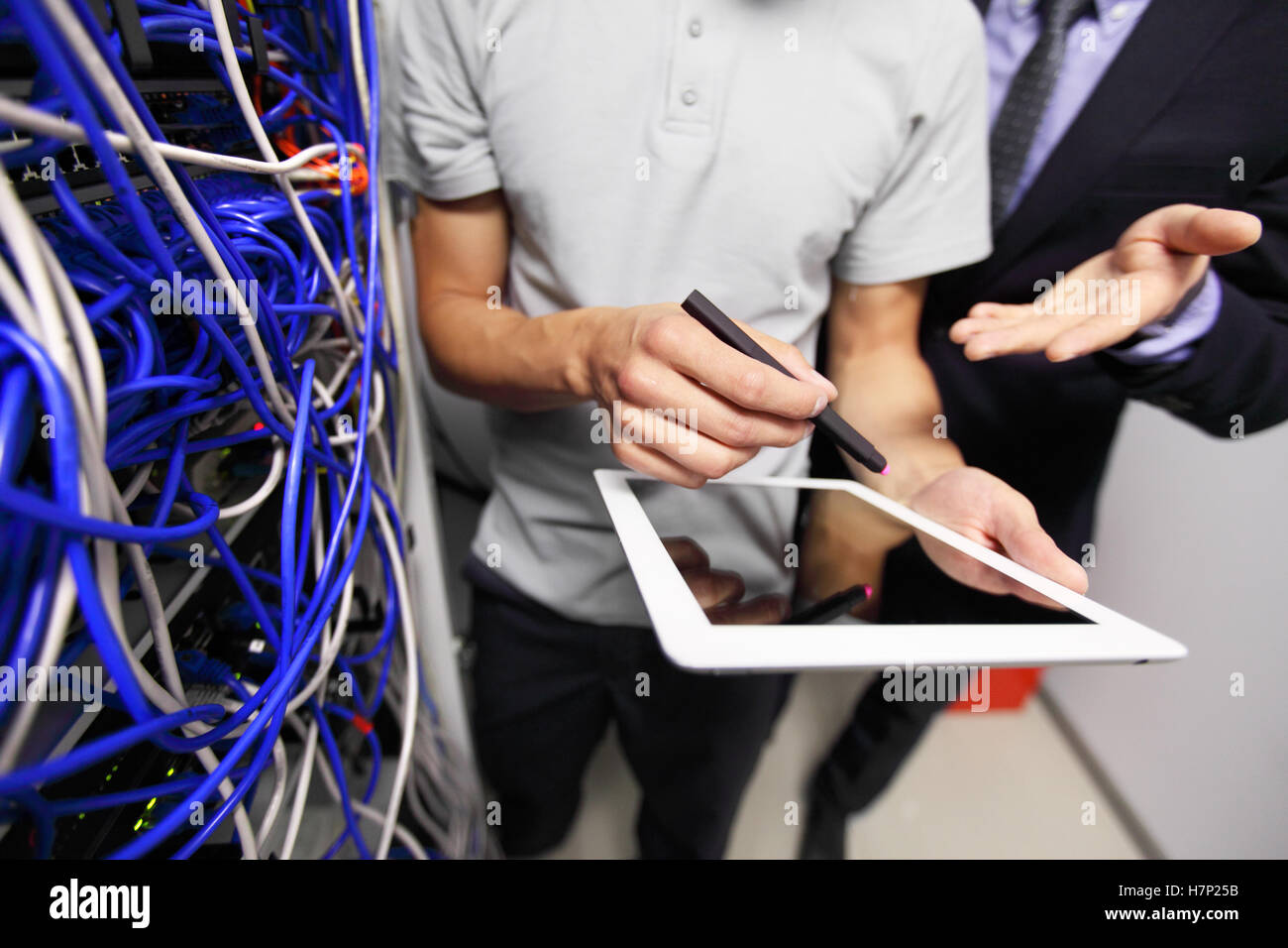 Men with tablet in data storage service room close up Stock Photo