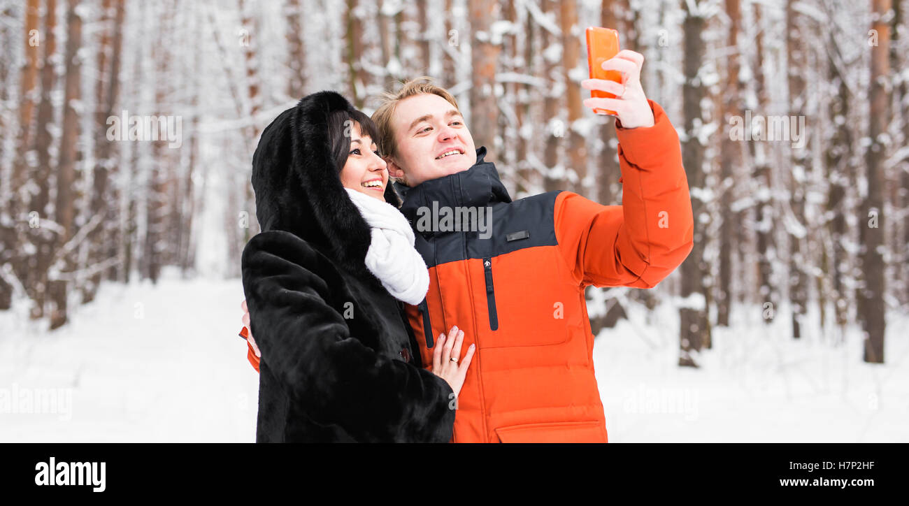 couple in love smiling and making selfie in winter outdoors Stock Photo ...