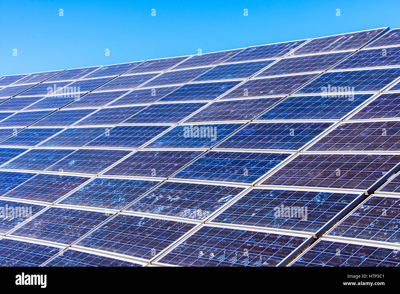 Close up of blue solar panels with blue sky, renewables Stock Photo