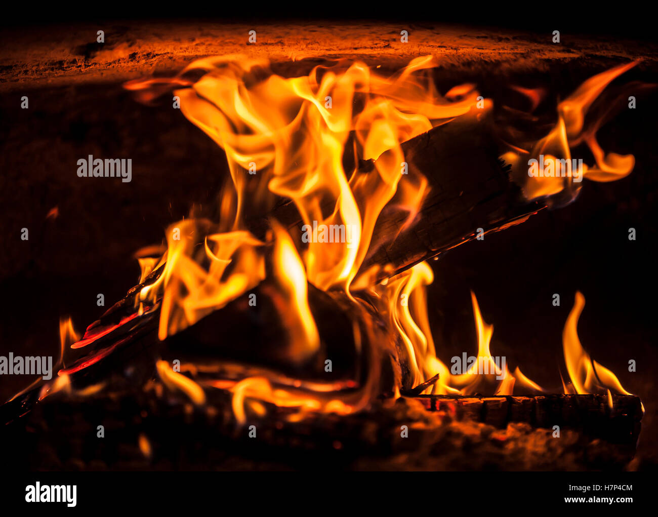 Open fire in the furnace producing heat. Stock Photo