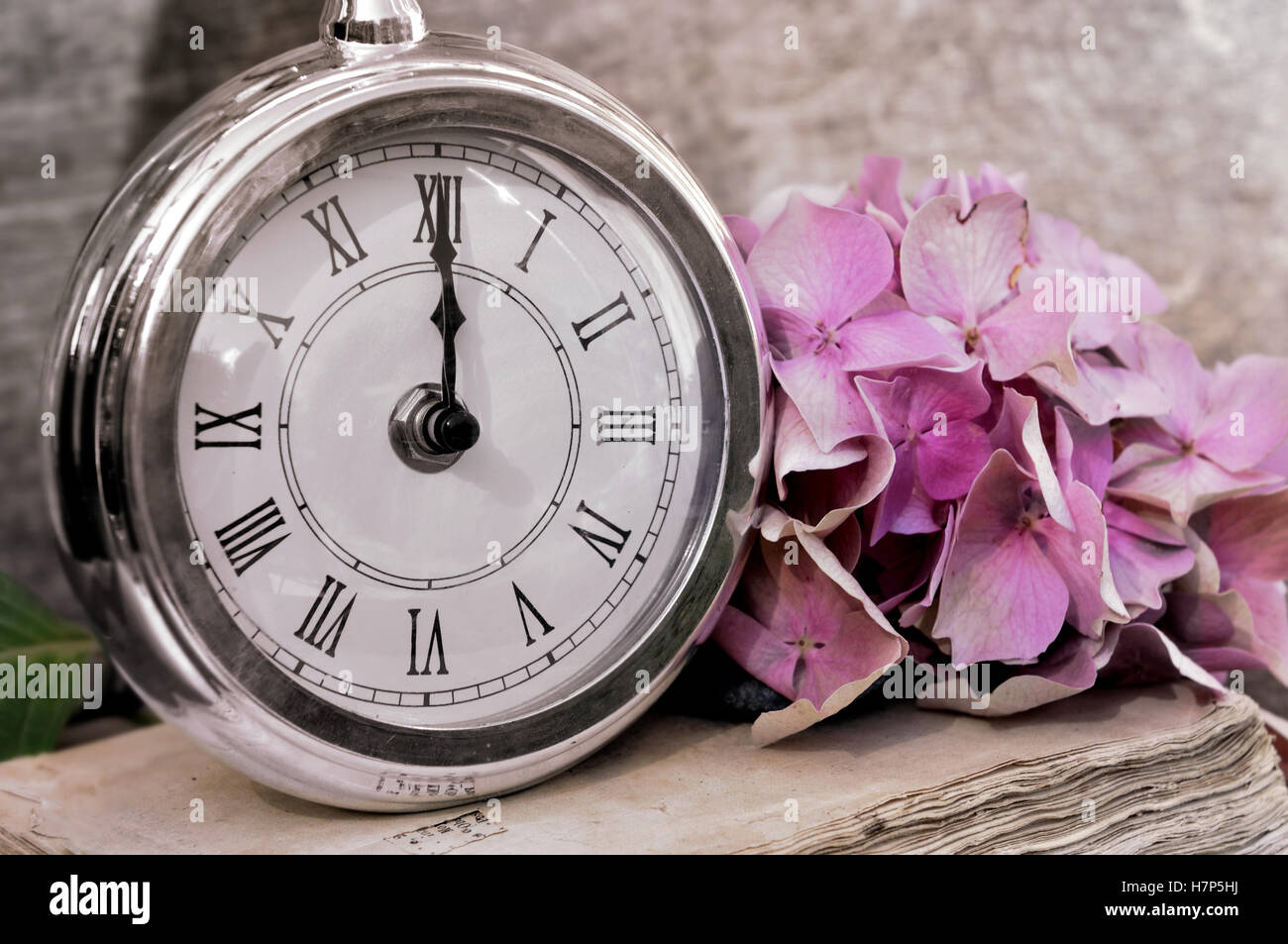 retro clock showing midnight in rustic background Stock Photo