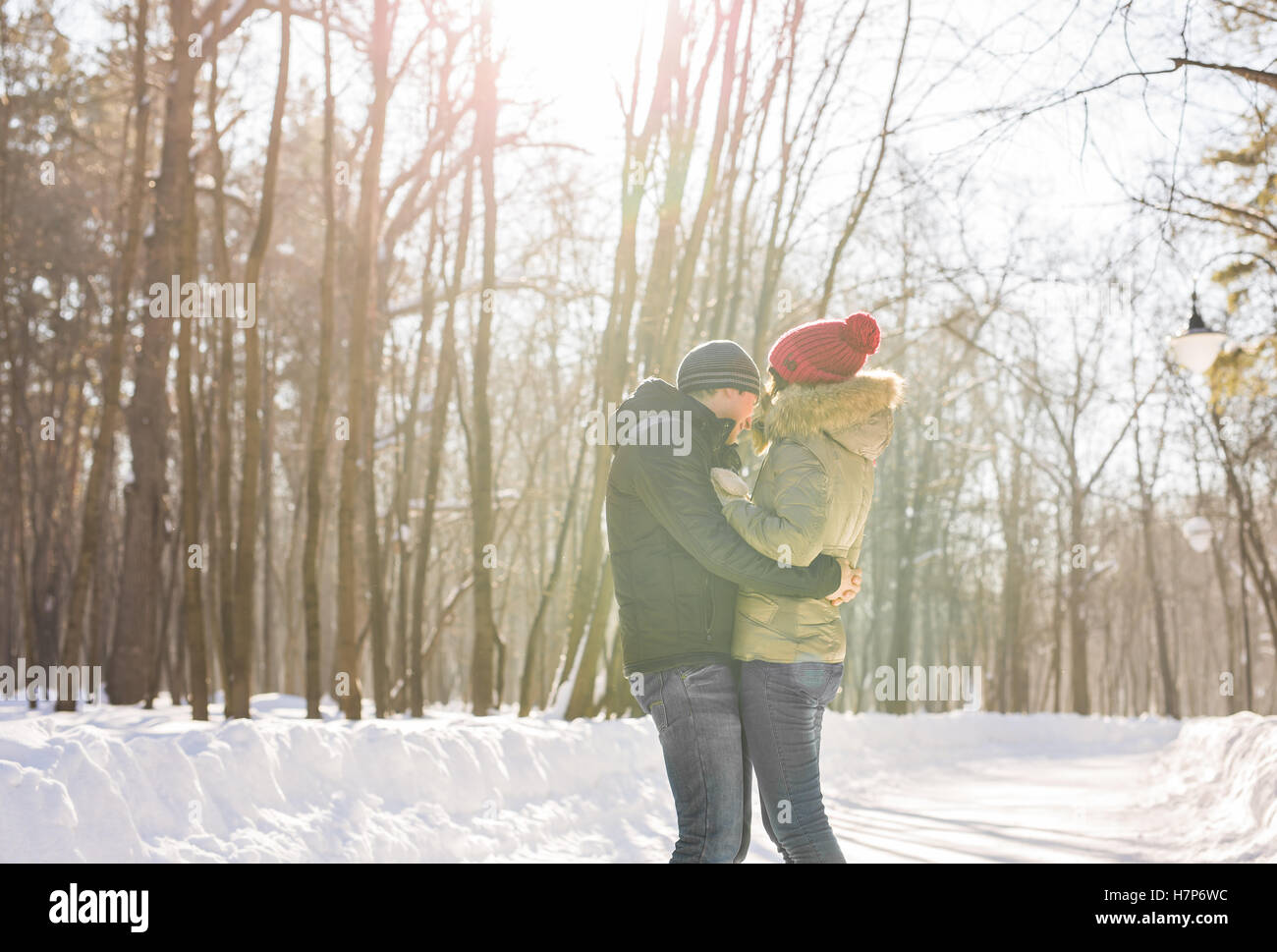 Young couple hugging and kissing in the Park in winter Stock Photo - Alamy