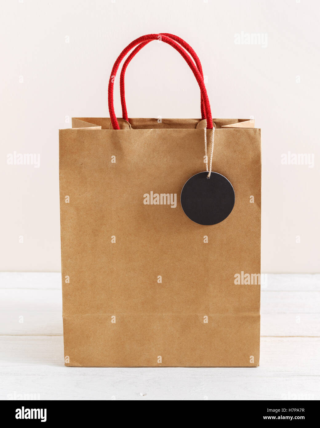 Download Brown Paper Shopping Bag With Black Tag And Red Rope Handle Stock Photo Alamy Yellowimages Mockups