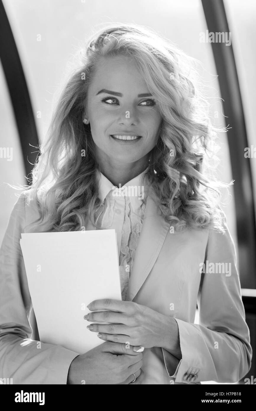 Black and white portrait of young beautiful smiling business lady Stock Photo