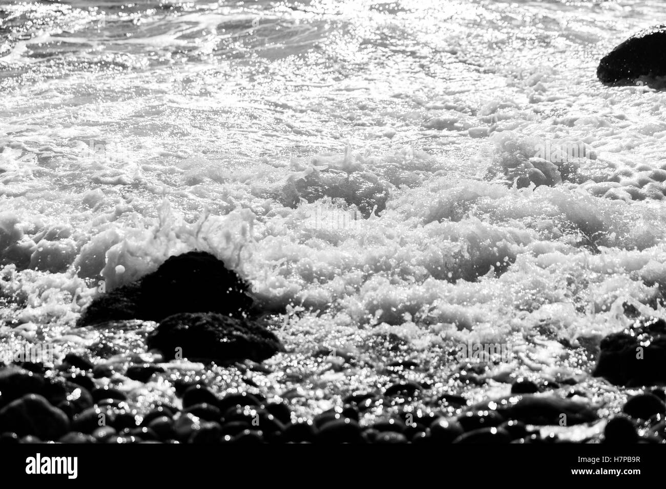 Stones among waves black-white photo Stock Photo