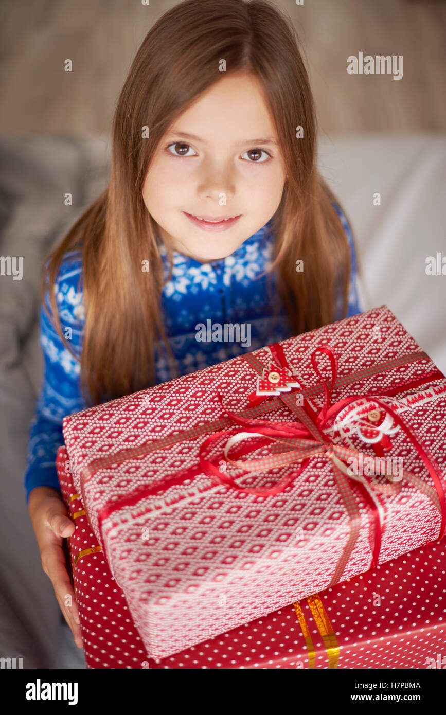 Cute girls holding big Christmas presents Stock Photo - Alamy