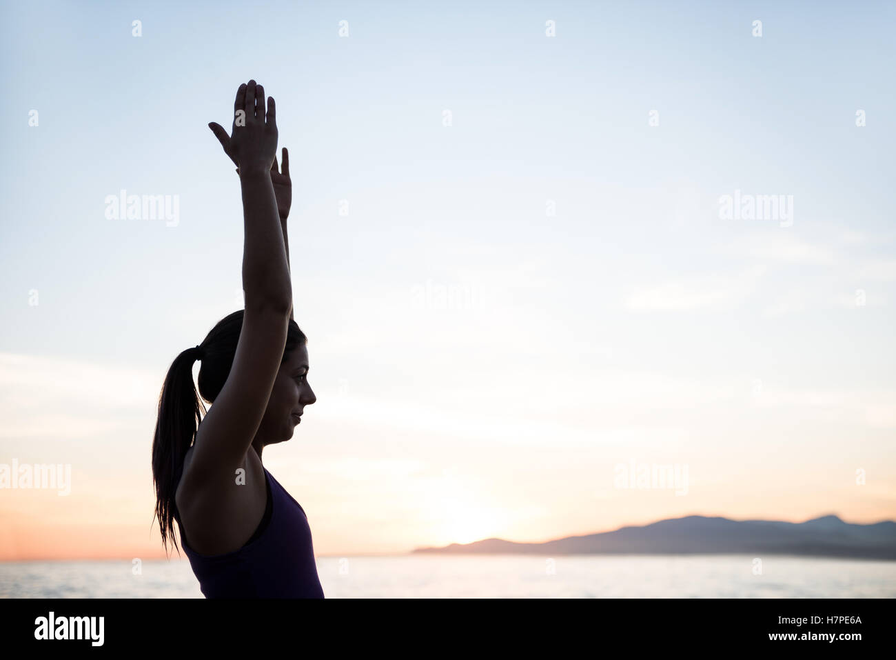 Woman performing yoga on beach Stock Photo Alamy