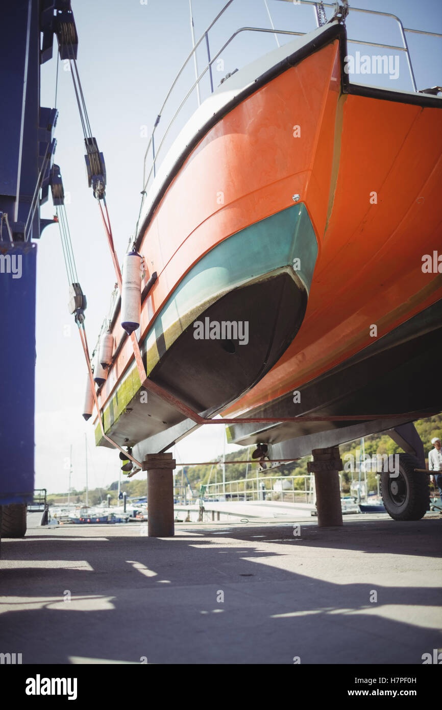 Boat on a hydro hoist boatlift Stock Photo Alamy