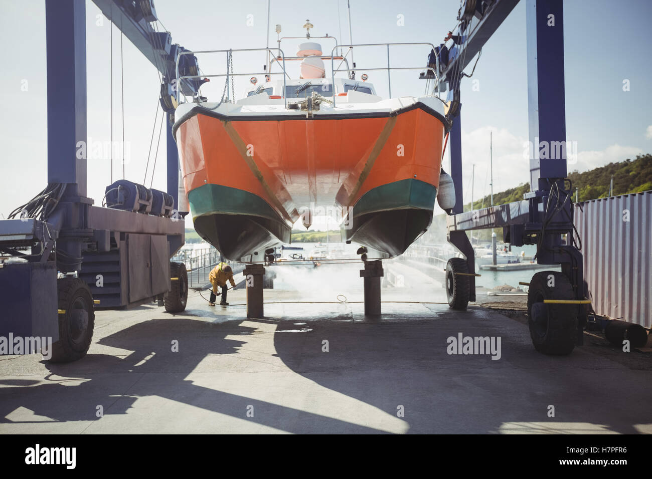 Man cleaning boat with pressure washer Stock Photo Alamy