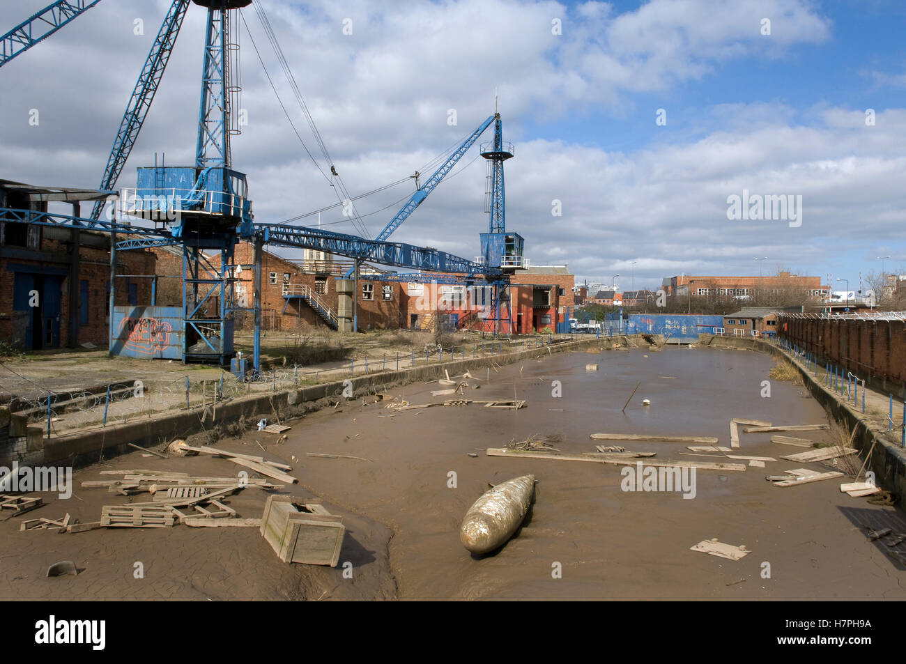 Historic graving (dry) dock full of silt and rubbish, Kingston upon