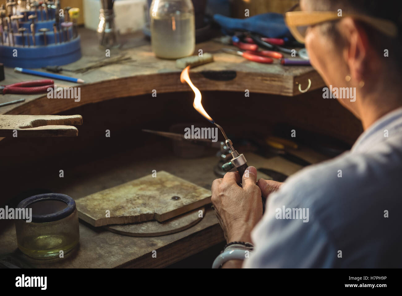 Craftswoman using blow torch Stock Photo - Alamy