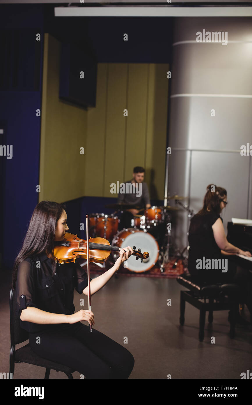 Two female students playing violin and piano Stock Photo - Alamy