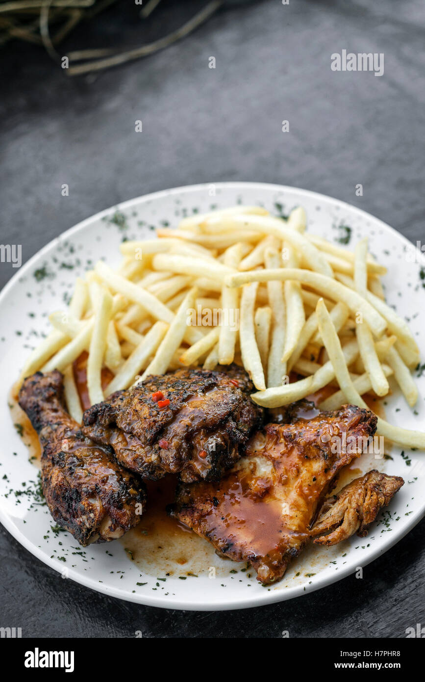 portuguese famous piri piri spicy bbq chicken with french fries meal Stock Photo