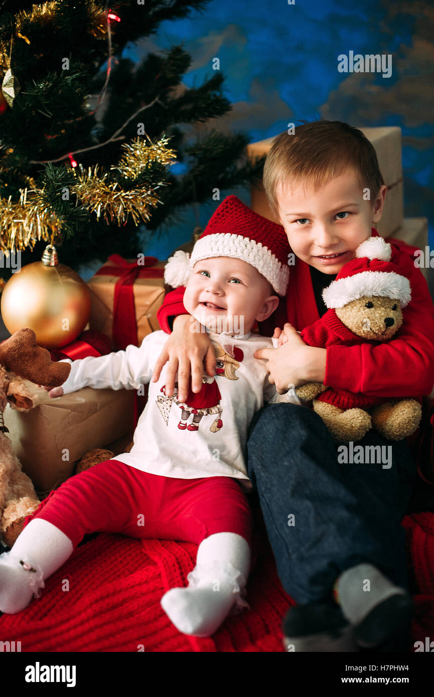 Portrait of happy children with Christmas gift boxes and decorations