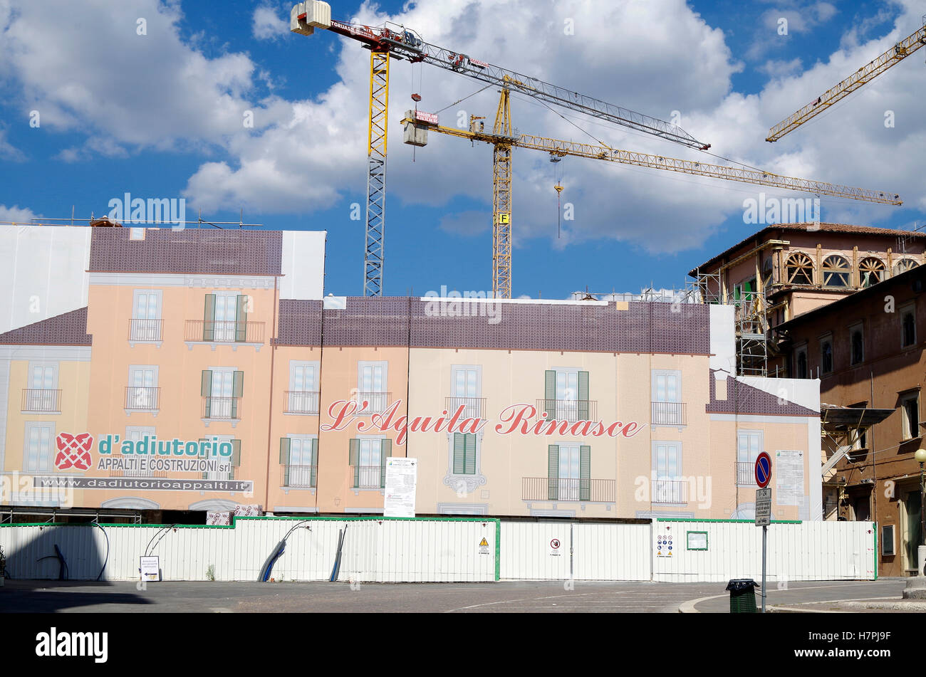 L'Aquila, Italy, Buildings in main square being rebuilt after 2009 earthquake, protective sheeting with illustration of building facades Stock Photo